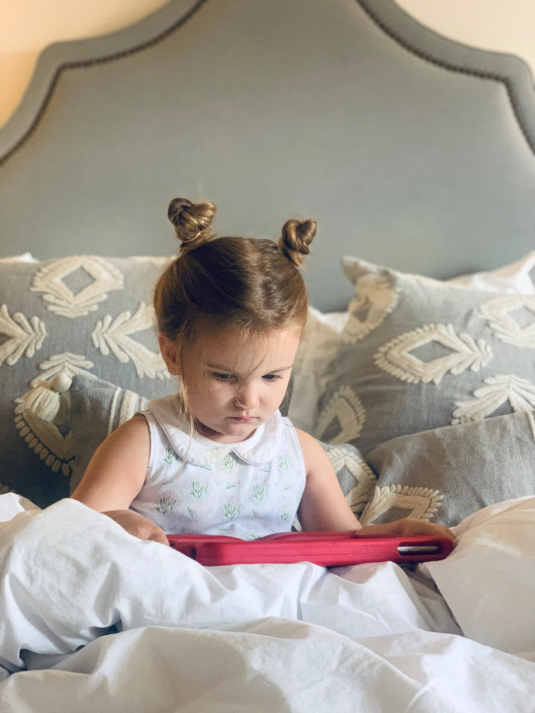 little girl ipad in bed