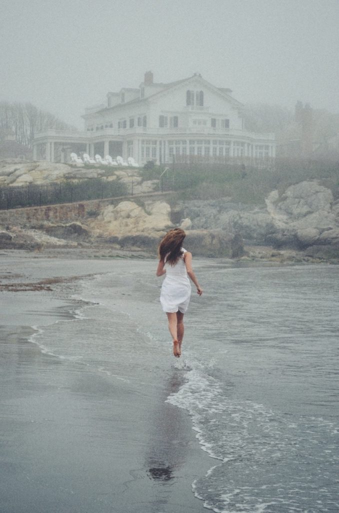 woman running in mist on beach