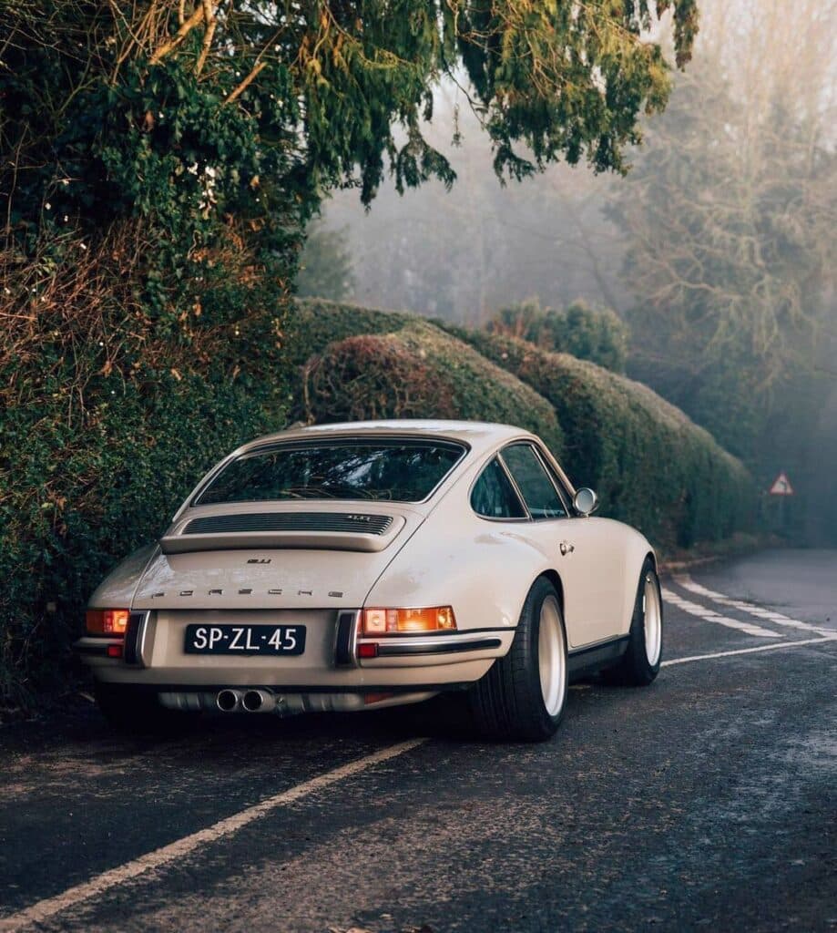 cream porsche on winding road