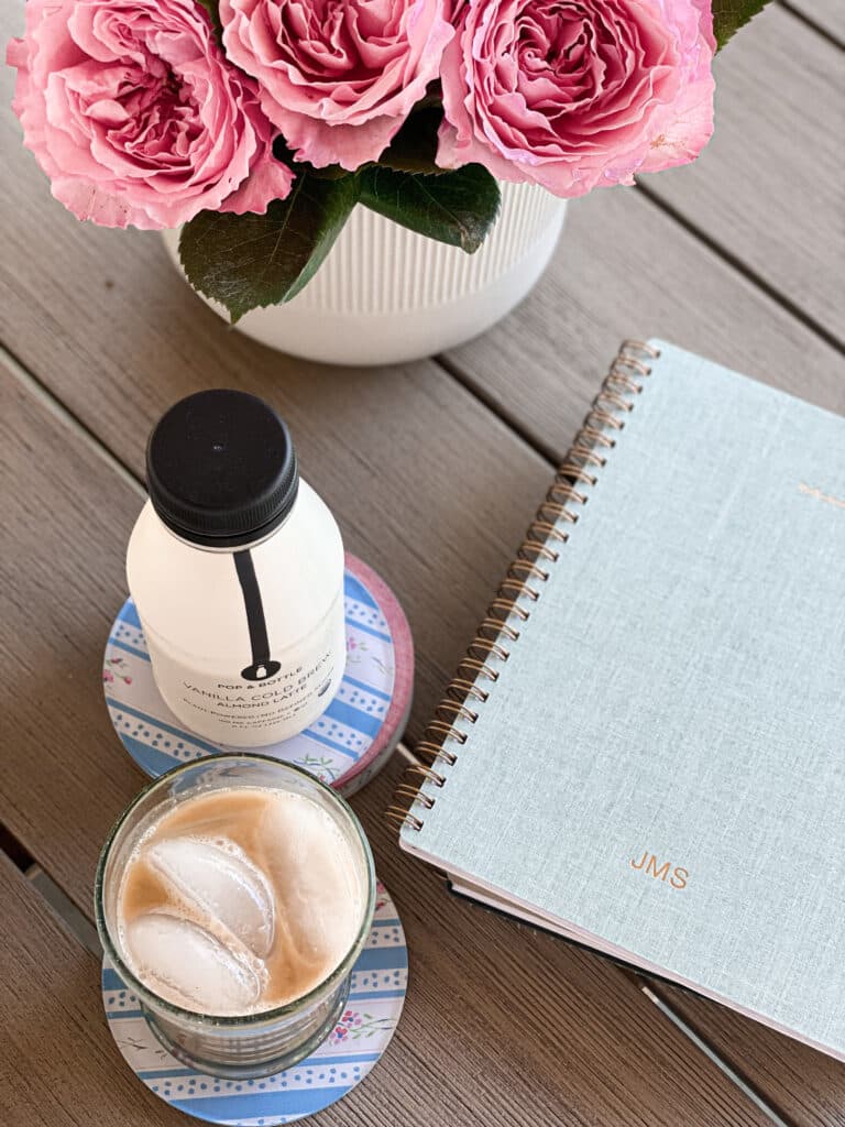 teak table with roses and iced coffee